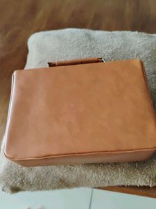 Stylish Tan Handbag with Flower Clasp