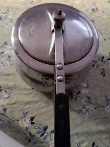 A silver pressure cooker