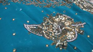 Teal Saree with Intricate Gold Embellishments