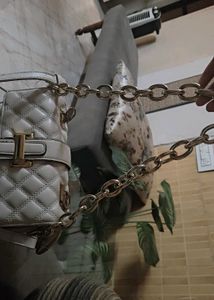 Beige sling bag along with chain slin