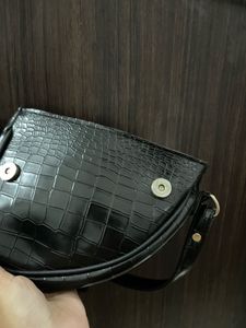 black textured shoulder bag