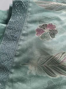 Elegant Teal Saree with Feather Motifs