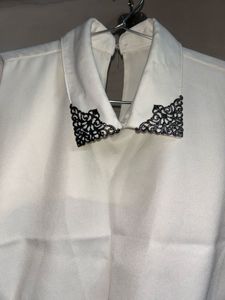 Sleeveless White Top with Black Lace Detail