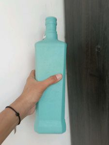 Decorative Teal Bottle with Vine Accent