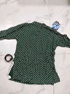 A beautiful dark green short kurti with embellish