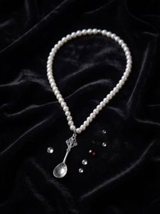 Elegant Pearl Necklace with Spoon Pendant