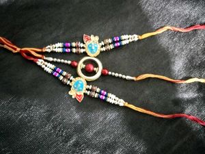 Elegant Rakhi with Red Pearls
