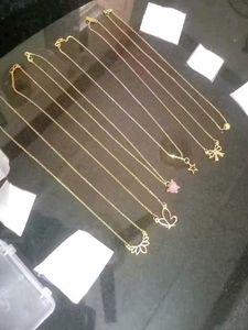 Set of dainty gold necklaces with charms
