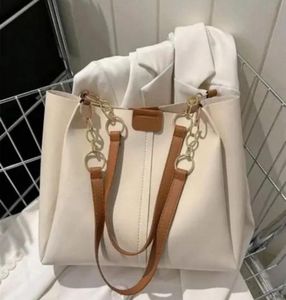 Chic Cream Tote Bag with Gold Chain Accents