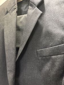 A crisp dark grey custom tailored suit
