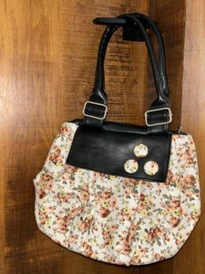 Chic Floral Handbag with Black Accents