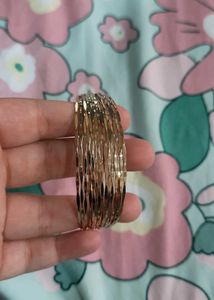 Elegant Gold Tone Twisted Bangle