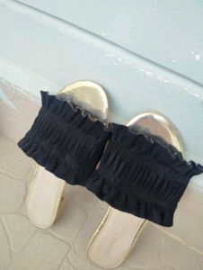 Chic Black Smocked Sandals with a Gold toned sole