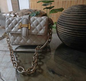 Beige sling bag along with chain slin