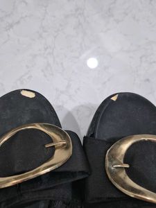 Stylish Black Slip-On Sandals with Gold Accent