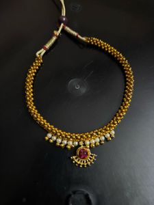 Elegant Gold Tone Necklace with Red Stone
