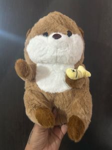 a brown cartoon otter holding tiny yellow fis