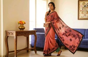 Elegant Coral Saree with Black Floral Print