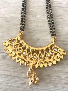 Shining Golden Mangalsutra With Ear Tops Medium Length With Stones/Diamond