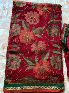 Maroon coloured Embroidered saree With Stitched blouse