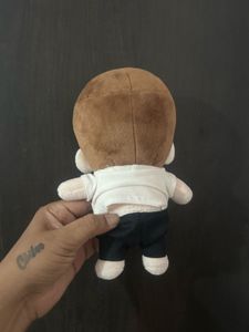 small cotton plush doll dressed in a casual white