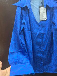 Vibrant Blue Button-Up Blouse with Geometric Patte