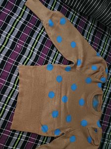 Tan color sweater top with blue dots