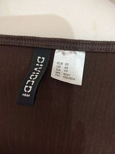 brown top with a small bow