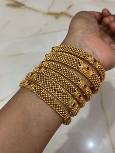 Set of 6 Gold Bangles with Red Stones