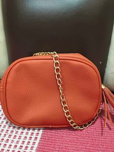 Chic Orange Crossbody Bag with Gold Chain