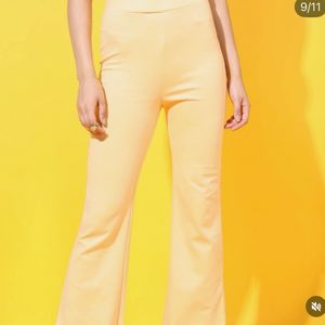 Yellow stretchable flared cotton trousers.