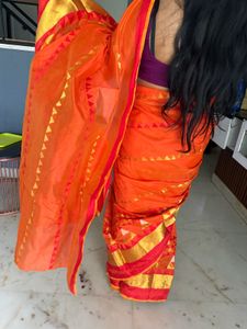 Vibrant Orange Saree with Golden Accents