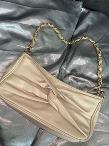 Elegant Cream Handbag with Gold Chain