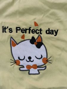 high neck pastel yellow top with embroiderd cat