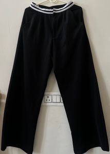 Black trousers with white stripe detail