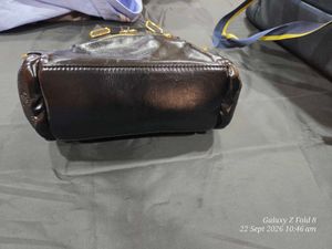 Chic Black Patent Clutch Bag with gold detailing.