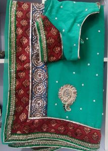 Elegant Teal Saree with Intricate Embellishments