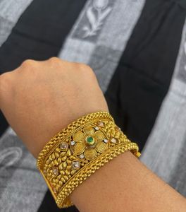 Traditional Gold Bangles with Intricate Floral De