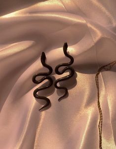 Handmade unequal pair of snake earrings