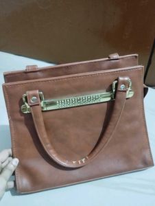 Chic Brown Handbag with Embellished Handle