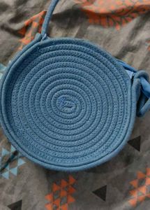 Chic Blue Woven Round Bag with Daisy Accent