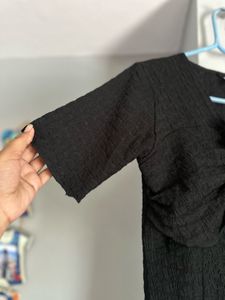 Chic Textured Black Top with Rose Detail