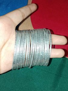 A dozen of silver metal bangles