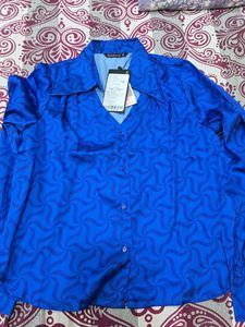 Vibrant Blue Button-Up Blouse with Geometric Patte