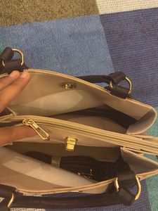 Elegant Beige Handbag with Black Handles