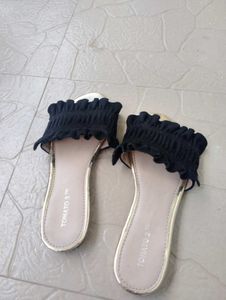 Chic Black Smocked Sandals with a Gold toned sole