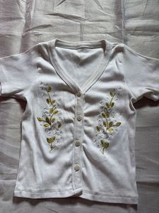 combo of White Embroidered Button-Up and ribbon bl