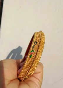 Exquisite Gold-Tone Bangles with Red Enamel Inlay