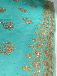 Exquisite Teal Saree with Golden Embellishments
