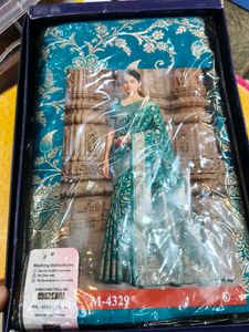 Elegant Teal Saree with Golden Motifs